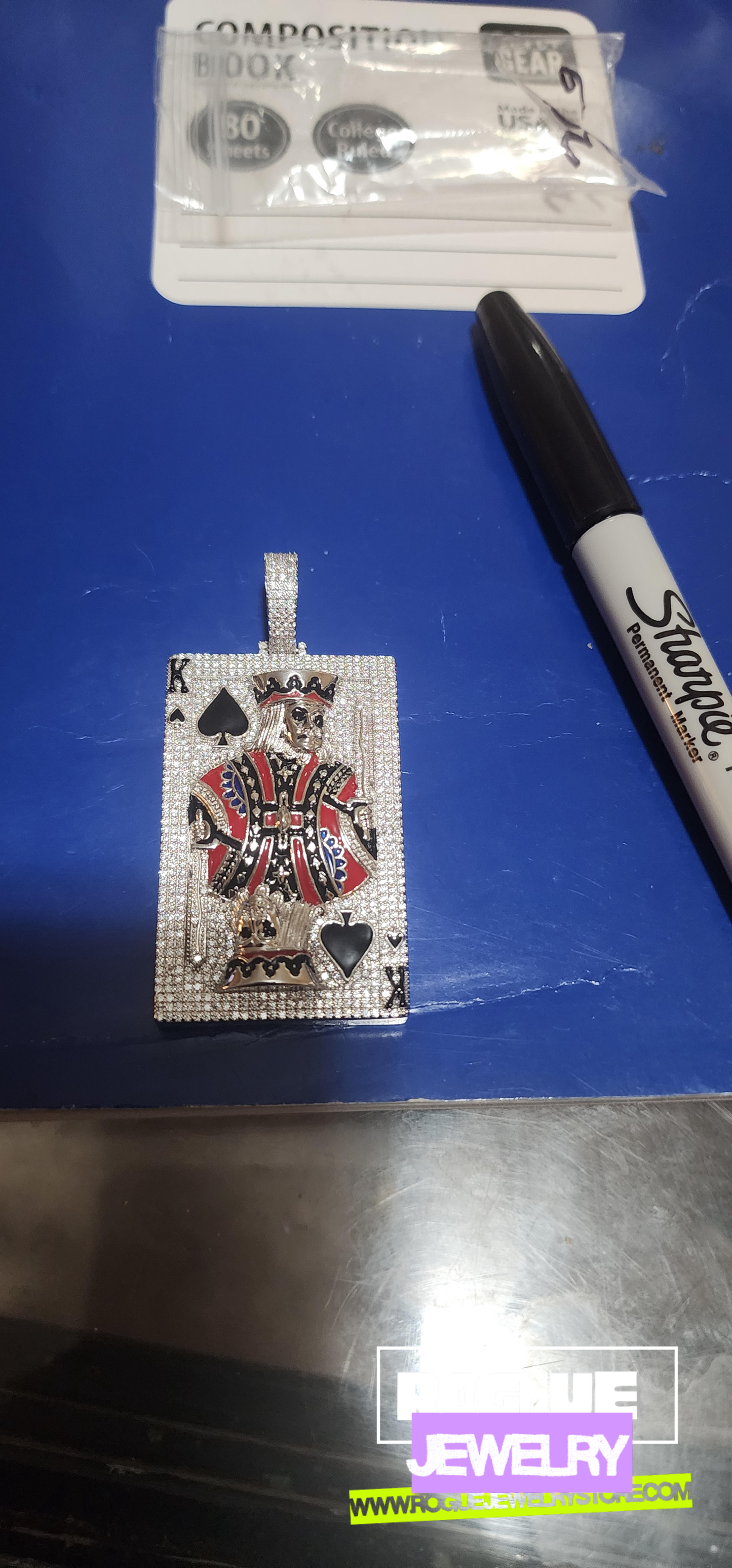 king of spades beside a marker at rogue jewelry store
